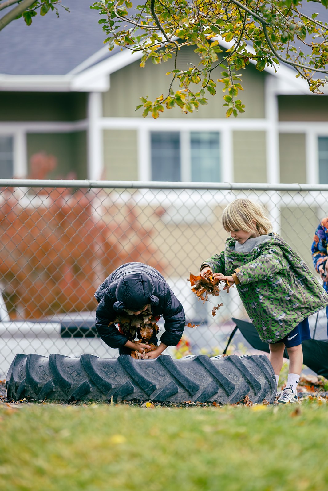 MSY children exploring autumn leaves outdoors