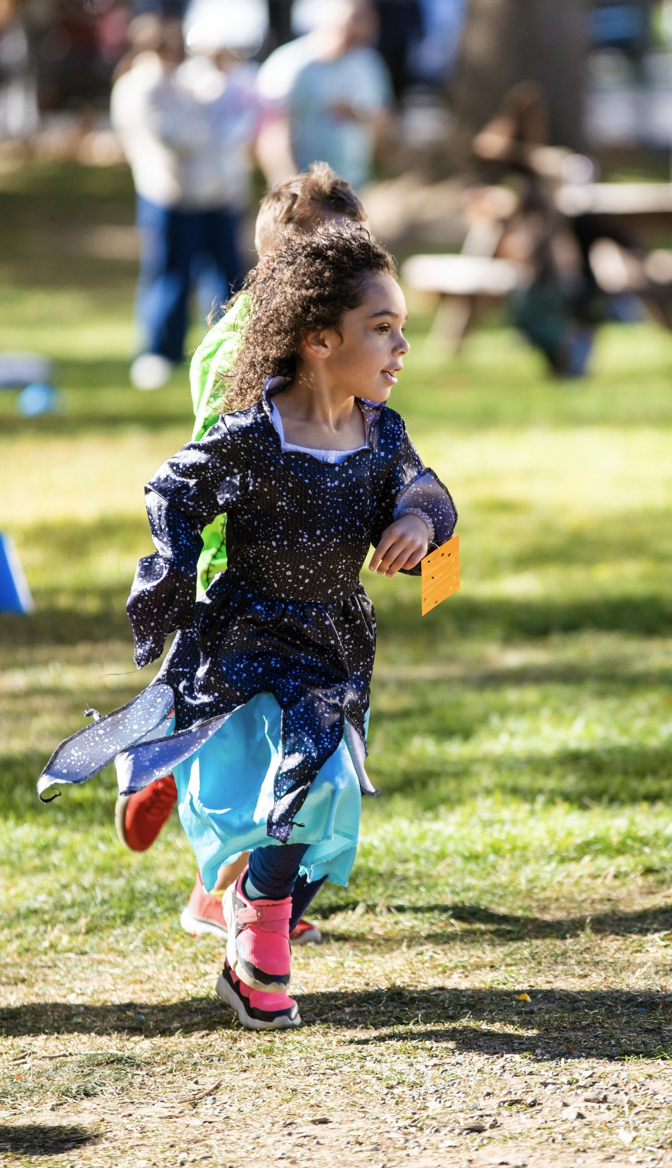 An MSY student running outdoors in a starry costume