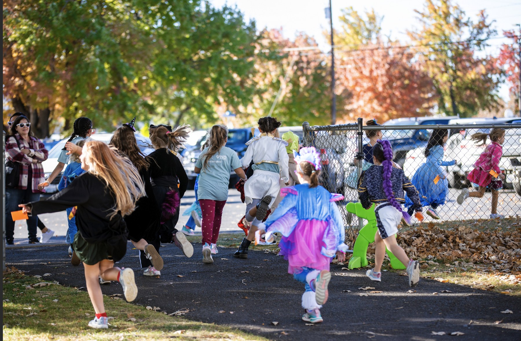 MSY students in costumes running together at an autumn school event